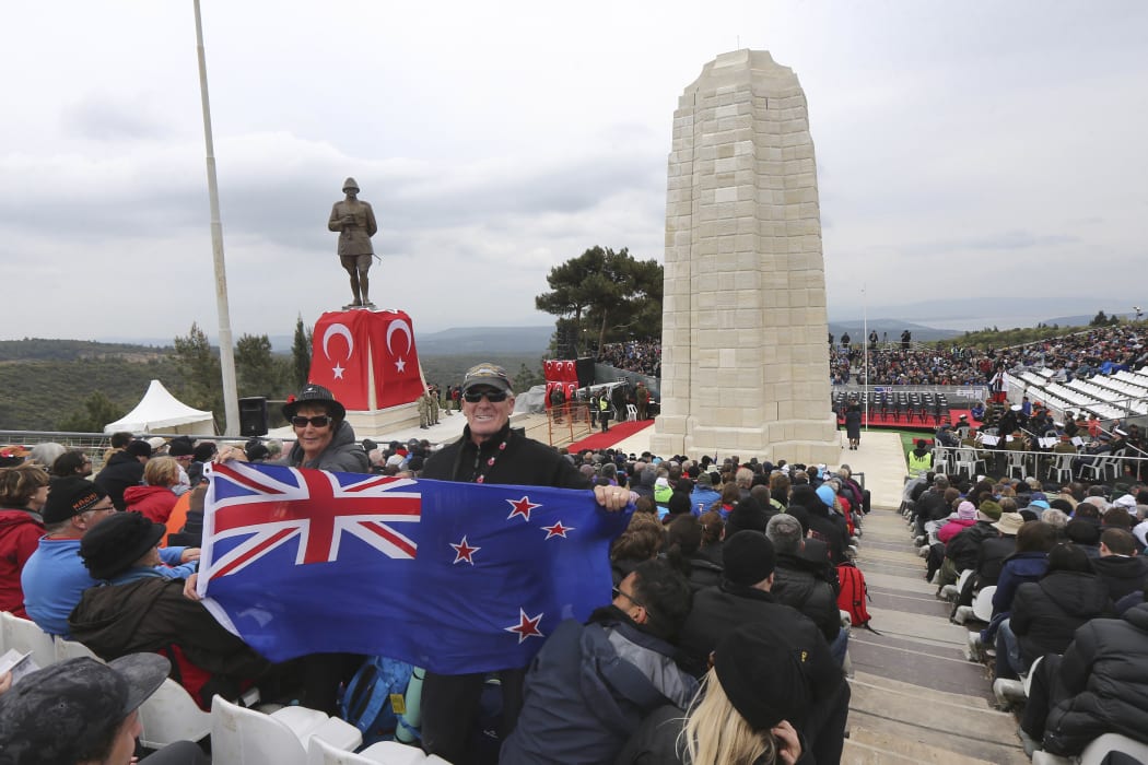 A New Zealand flag being held at a memorial service in April 2015 in front of Ataturk Memorial on Chunuk Bair near Anzac Cove in Gallipoli.