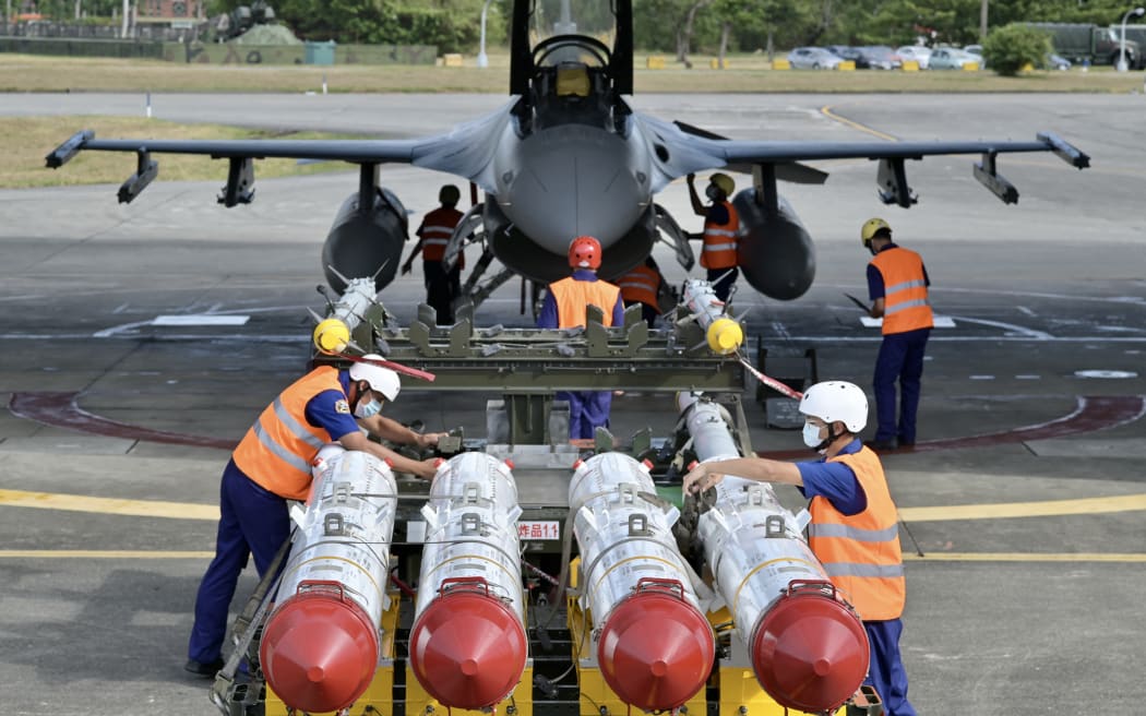Air Force soldiers prepare to load US made Harpoon AGM-84 anti ship missiles in front of an F-16V fighter jet during a drill at Hualien Air Force base on 17 August, 2022.