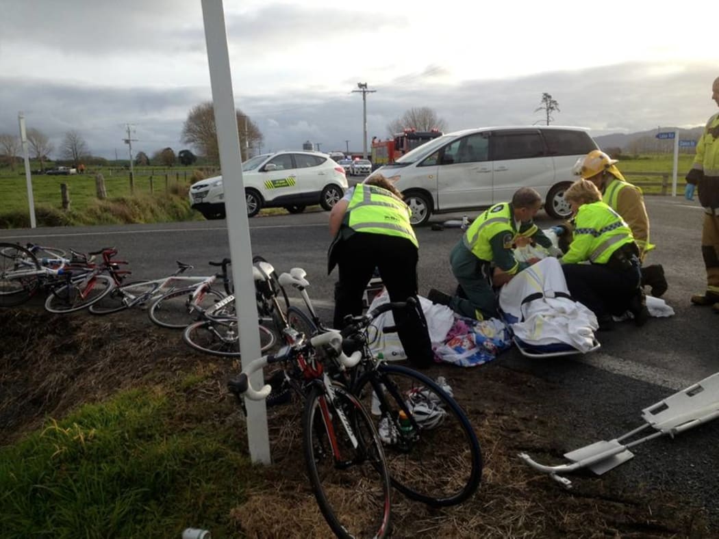 Paramedics tend to one of the cyclists.