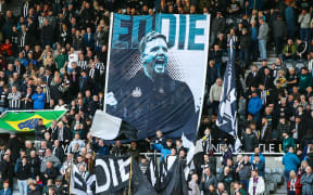 Newcastle United supporters hold a banner of coach Eddie Howe.