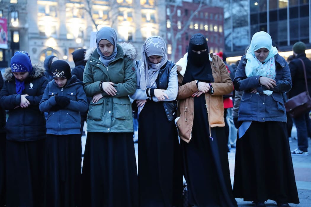 Muslim women pray before a protest in lower Manhattan against the polices of President Donald Trump on February 1, 2017 in New York City.