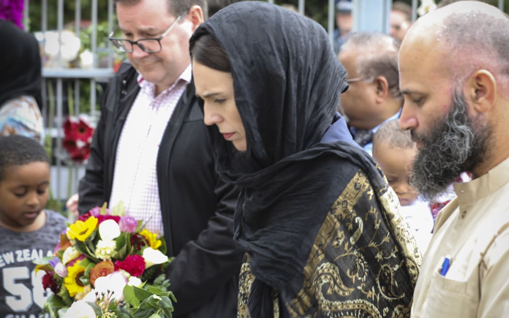 Jacinda Ardern places flowers at the Wellington Islamic Centre in remembrance of the lives lost in Christchurch