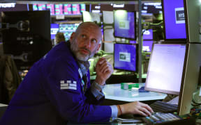 Traders work on the floor of the New York Stock Exchange (NYSE) at the opening bell on April 9, 2025, in New York City. Wall Street stocks were mixed in early trading Wednesday as markets digested the latest tariff hike by the United States and retaliatory moves by China and the European Union.