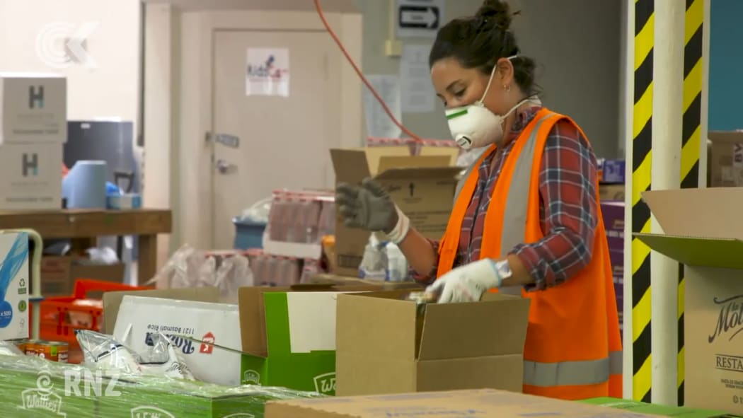 KidsCan workers fill boxes to deliver to families in need under lockdown.