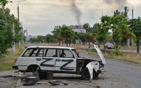 A damaged car on the street in Severodonetsk, the scene of fierce street battles in recent days. Russian force now control most of the city.