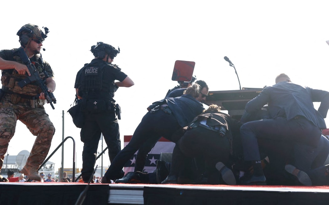 BUTLER, PENNSYLVANIA - JULY 13: Republican presidential candidate former President Donald Trump is rushed offstage during a rally on July 13, 2024 in Butler, Pennsylvania.   Anna Moneymaker/Getty Images/AFP (Photo by Anna Moneymaker / GETTY IMAGES NORTH AMERICA / Getty Images via AFP)