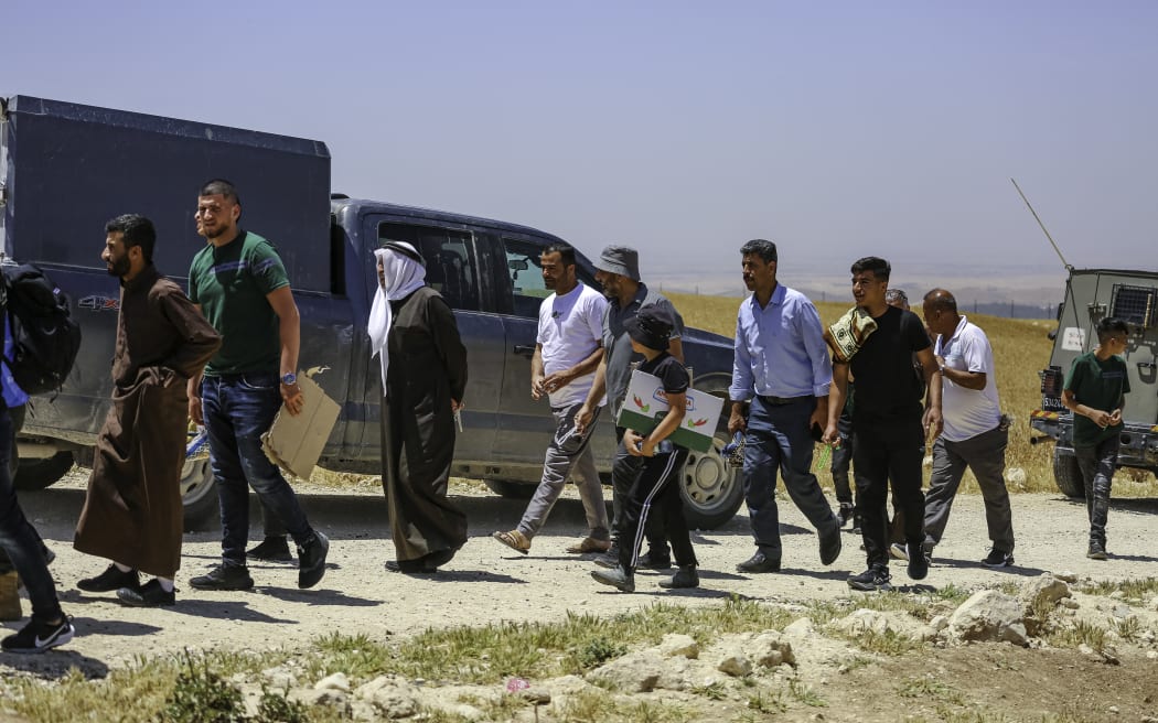 Palestinians leave the scene after performing Friday prayers near the lands that Israeli settlers are threatening to confiscate, after the armed Israeli forces prevented them from reaching their lands, in the Dhahiriya area, south of Hebron, on May 9, 2025. (Photo by Mosab Shawer / Middle East Images / Middle East Images via AFP)