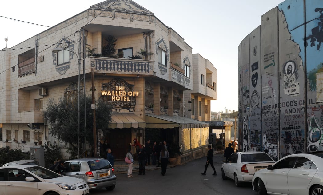 A picture taken on December 20, 2019 shows British artist Banksy's Walled-Off Hotel facing Israel's controversial separation wall in the occupied West Bank town of Bethlehem.