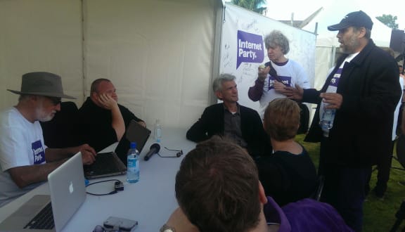 Kim Dotcom (seated left) listening to party members at the internet party picnic.