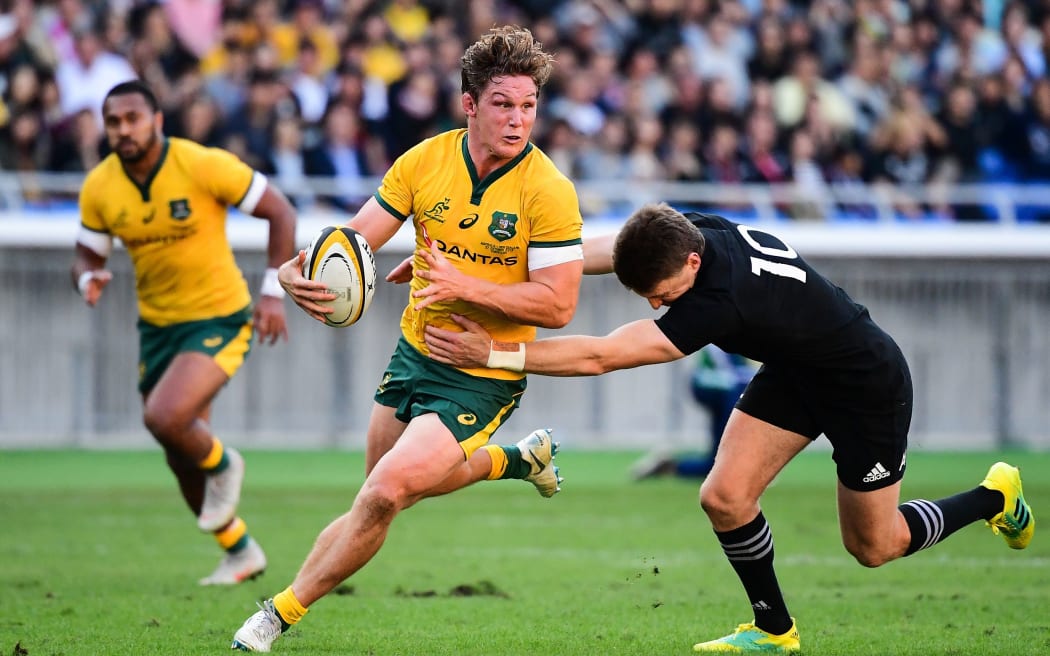 Beauden Barrett of New Zealand tackles Australia's Michael Hooper.