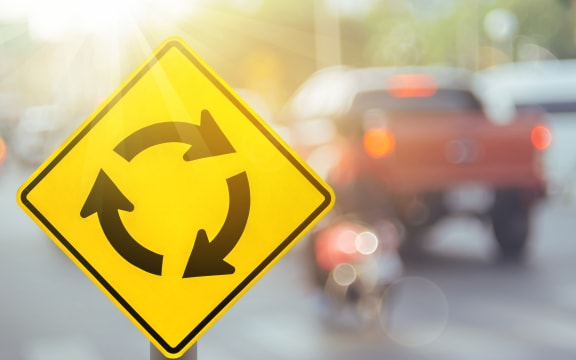 Stock photo of a roundabout sign.