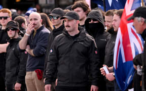 National Socialist Network member Thomas Sewell (C) leads his supporters during a "March for Australia" anti-immigration rally in Melbourne on August 31, 2025. (Photo by William WEST / AFP)