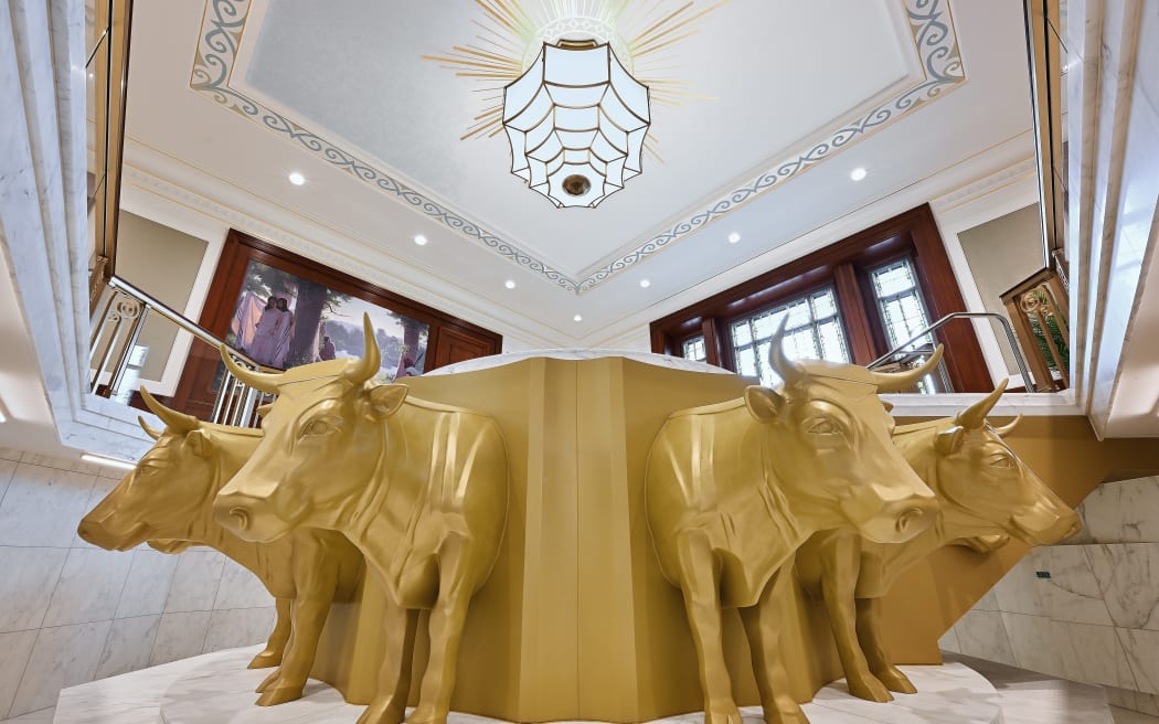 Gold coloured oxen appear to carry the pool in the Bapistery within the temple