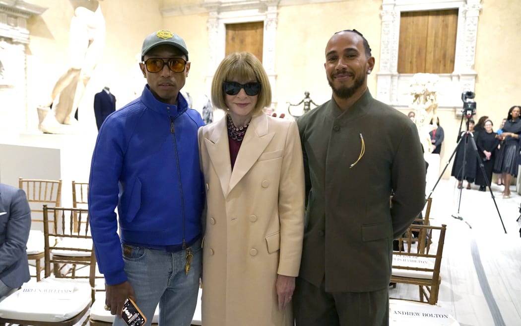 Met Gala celebrity Pharrell Williams and Lewis Hamilton pose with Vogue editor Anna Wintour at the Metropolitan Museum of Art's Costume Institute during a press conference October 9, 2024 to announce the Met Gala theme “Superfine: Tailoring Black Style,” that will be launched by the Met Gala on May 5.