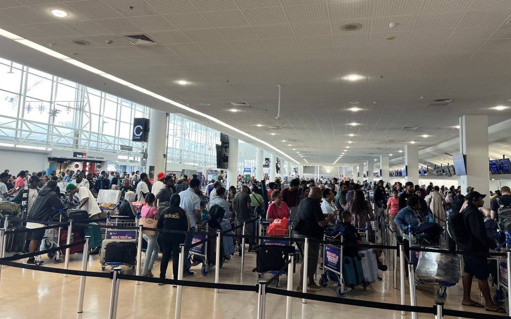 Crowds at Auckland Airport as travelers head away for Christmas 2024.