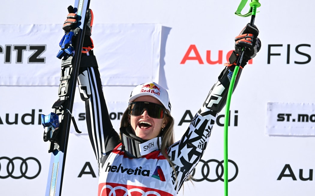 First-placed New Zealand's Alice Robinson celebrates on the podium after the Women's Super G event of the FIS Alpine Skiing World Cup 2025-2026, in St. Moritz.