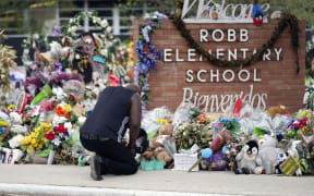 Reggie Daniels pays his respects at a memorial outside Robb Elementary School, on 9 June, 2022, in Uvalde, Texas, created to honor the victims killed in the school shooting.