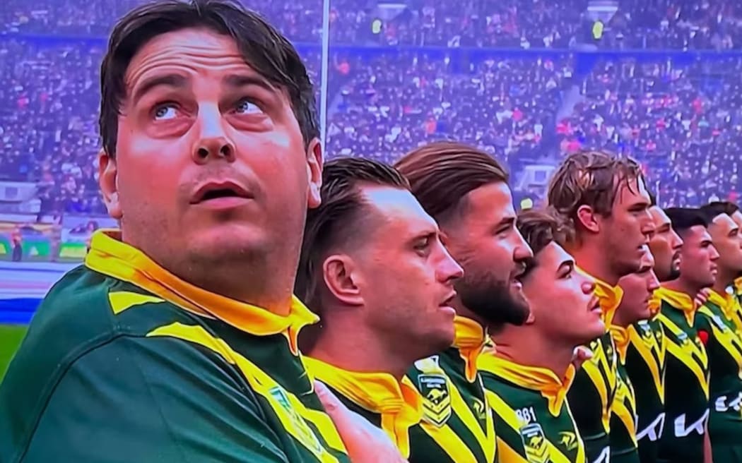 Daniel Jarvis (left) stood with the Kangaroos as the national anthems were played before kick-off. (X: Craig Wall)