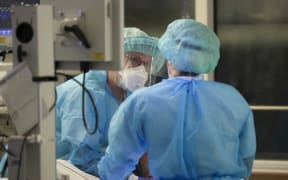 A specialist and an intensive care nurse intubate a Covid-19 patient in the intensive care unit of Leipzig University Hospital, Germany.