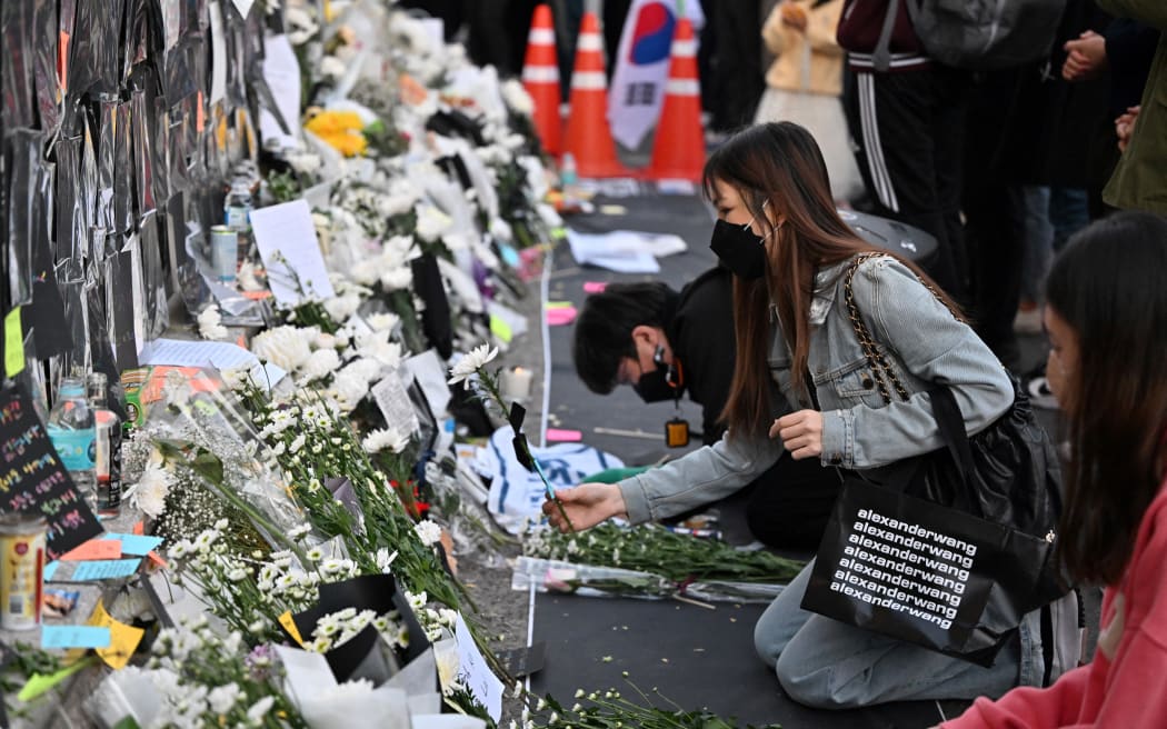 Mourners pay tributes at a makeshift memorial for the victims of the deadly Halloween crowd surge, outside a subway station in the district of Itaewon in Seoul on 1 November, 2022.