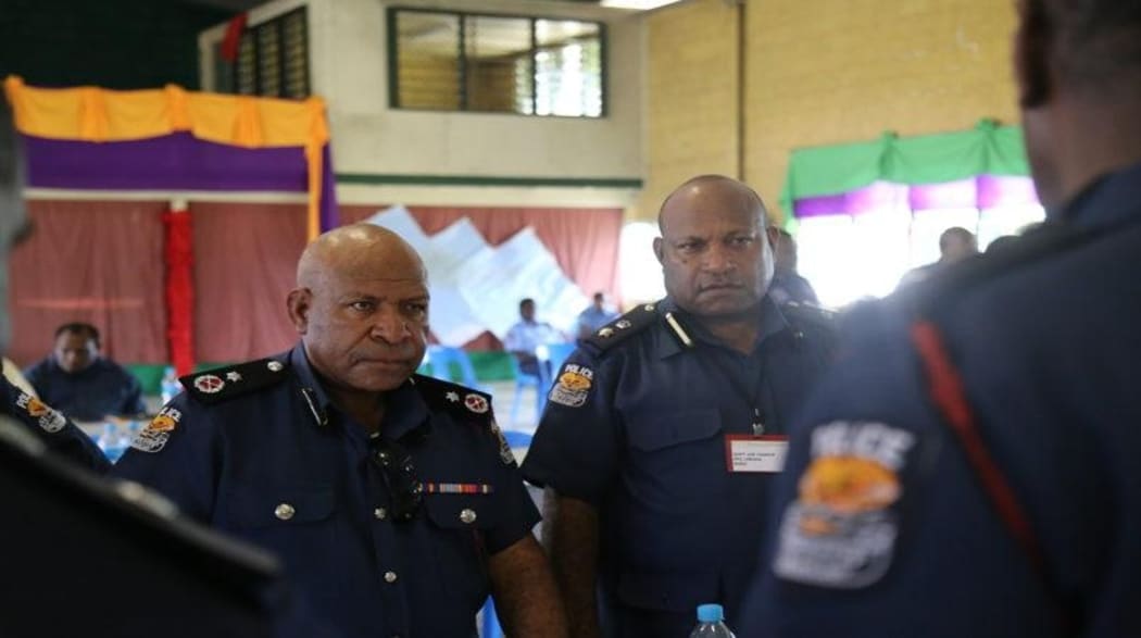 Former Papua New Guinea acting police commissioner Teddy Tei (left)