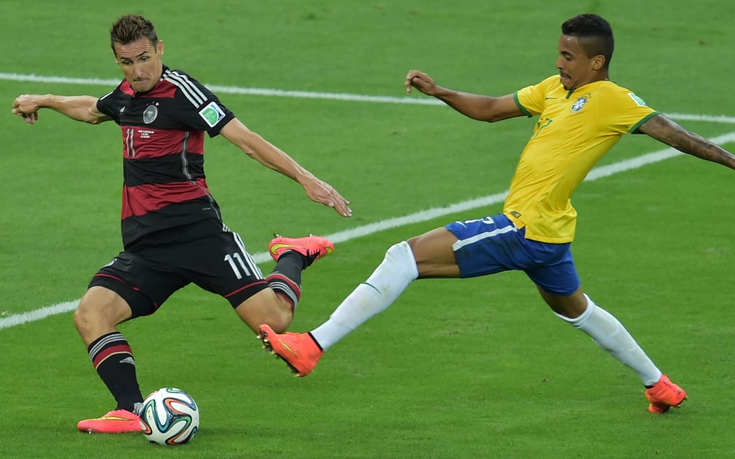 Germany's forward Miroslav Klose scores the second goal during the semi-final football match between Brazil and Germany.