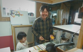 Seung Yul Oh at home with his daughter