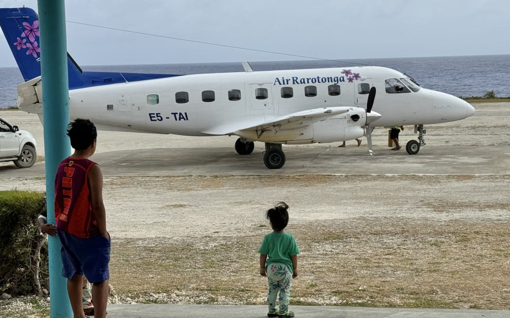 Mangaian locals wait to meet family arriving from Rarotonga.