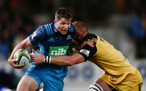 Matt Duffie of the Blues fends against Brad Shields of the Hurricane