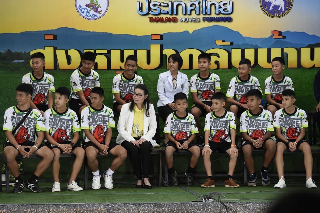 Twelve Thai boys and their football coach, rescued from a flooded cave after being trapped, attend a press conference in Chiang Rai on July 18, 2018.