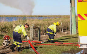 Fire crews south of Ashburton battled a large rural blaze burning through around 14,000 hay bales on Thursday.