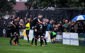 Team Wellington celebrate a goal during the grand final first leg.
