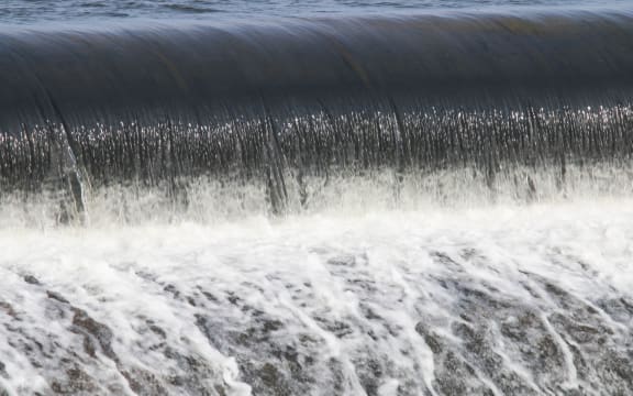 Building a man-made dam to store water for the dry season.