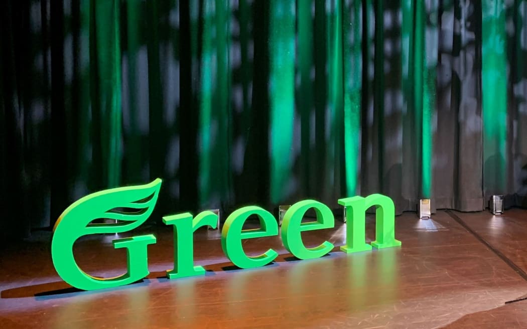 Green Party logo on a stage