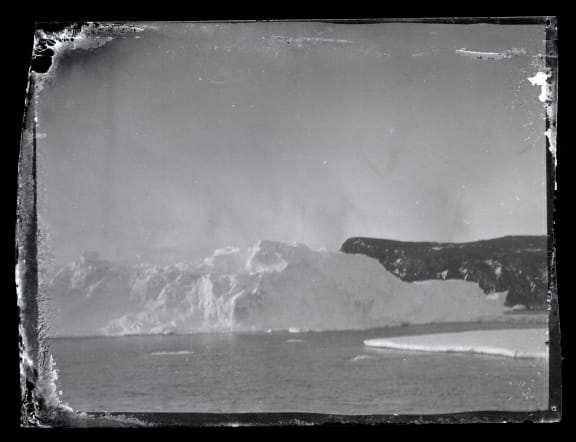 Iceberg and land at Ross Island in Antarctica.