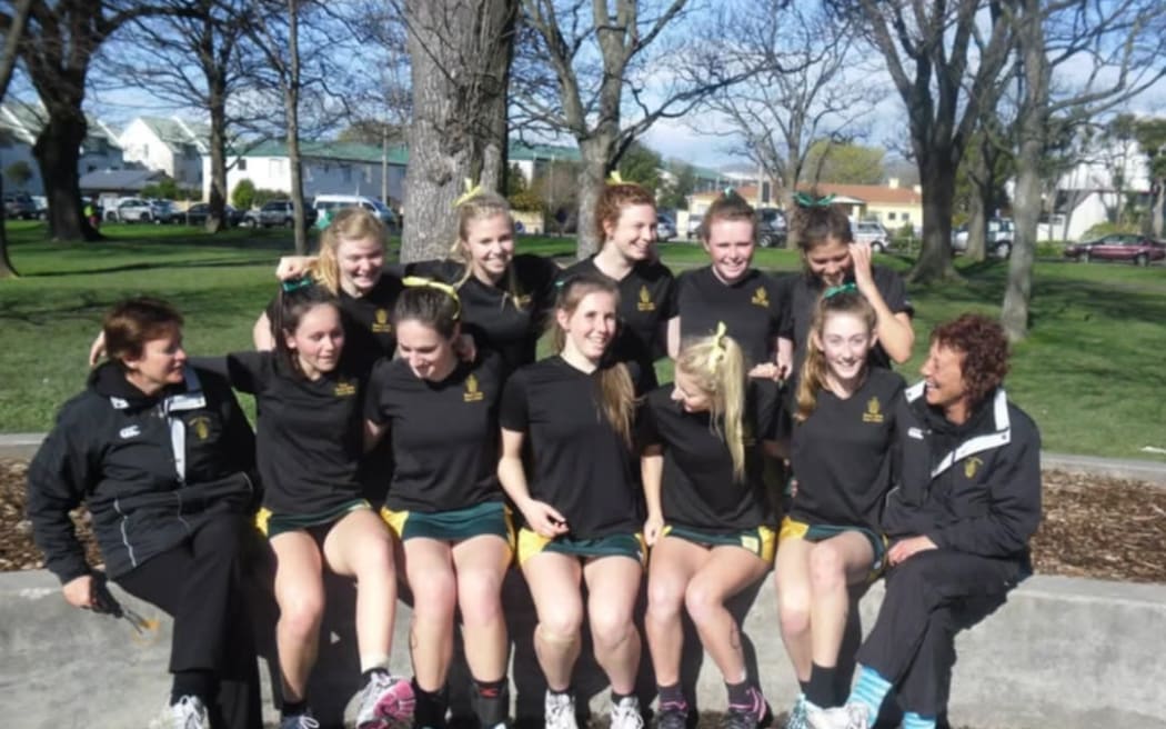 Coach Lyn Fleming, left and Faye Eden, right, with one of the netball teams they coached.