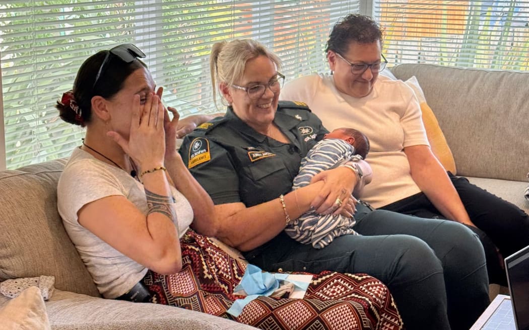 Lia Milich (left) wipes away tears of joy after meeting Hato Hone St John call handler Anna Evans, who helped Kristene Milich (right) deliver her daughter's baby Luka in the family's bathroom during a 111 call. May 7, 2025