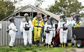Workers from the Danish Veterinary and Food Administration and the Danish Emergency Management Agency wearing protective equipment to kill minks in Gjol, Denmark, on 8 October, 2020.