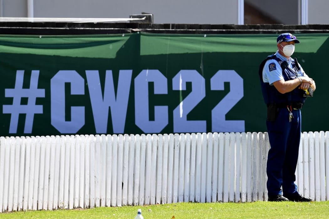 A police officer stands guard during the warm up fifty overs match between England and Bangladesh at Lincoln Green in Lincoln on February 28, 2022, ahead of the ICC Women's Cricket World Cup.