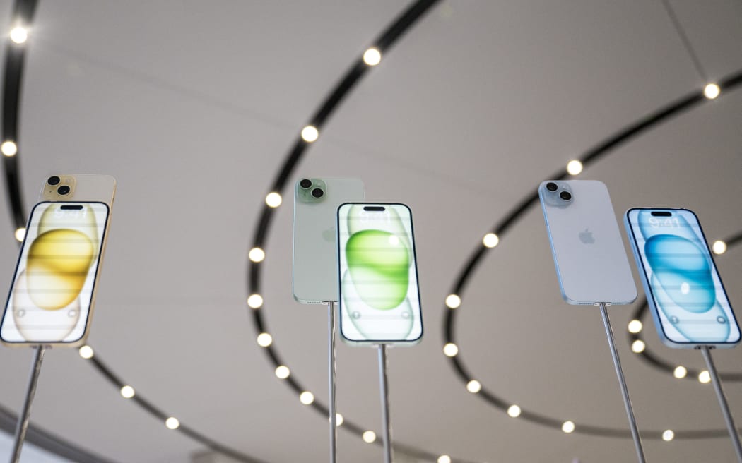 The new Apple iPhone 15, with EU ordered USB-C charger, is displayed amongst other new products during a launch event at Apple Park in Cupertino, California, on September 12, 2023. (Photo by Nic Coury / AFP)