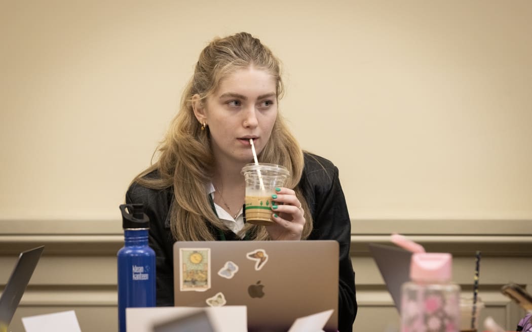 Julie Anne Genter's Youth MP Zara Barlow sips on a takeaway coffee during a short break from chairing a select committee.