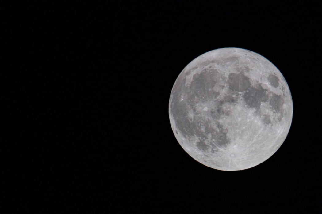 The first full moon of summer 2021, also known as the Strawberry Moon, the last supermoon of 2021 as seen in the Greek sky in Thessaloniki, Greece on June 24, 2021. (Photo by Nicolas Economou/NurPhoto) (Photo by Nicolas Economou / NurPhoto / NurPhoto via AFP)