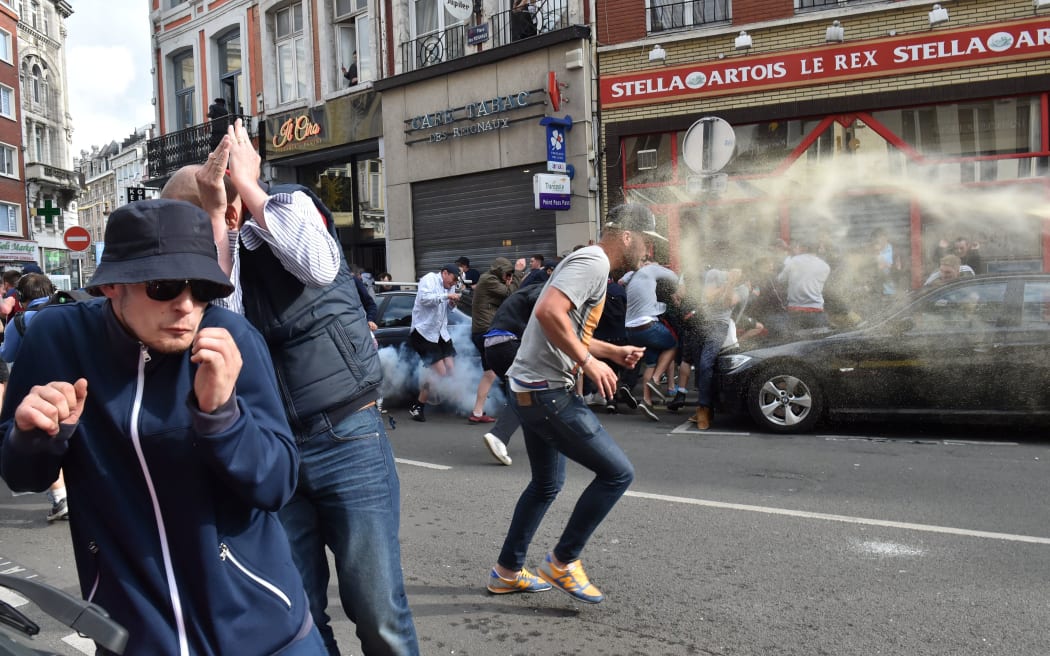 Football fans clash with police officers in central Lille.
