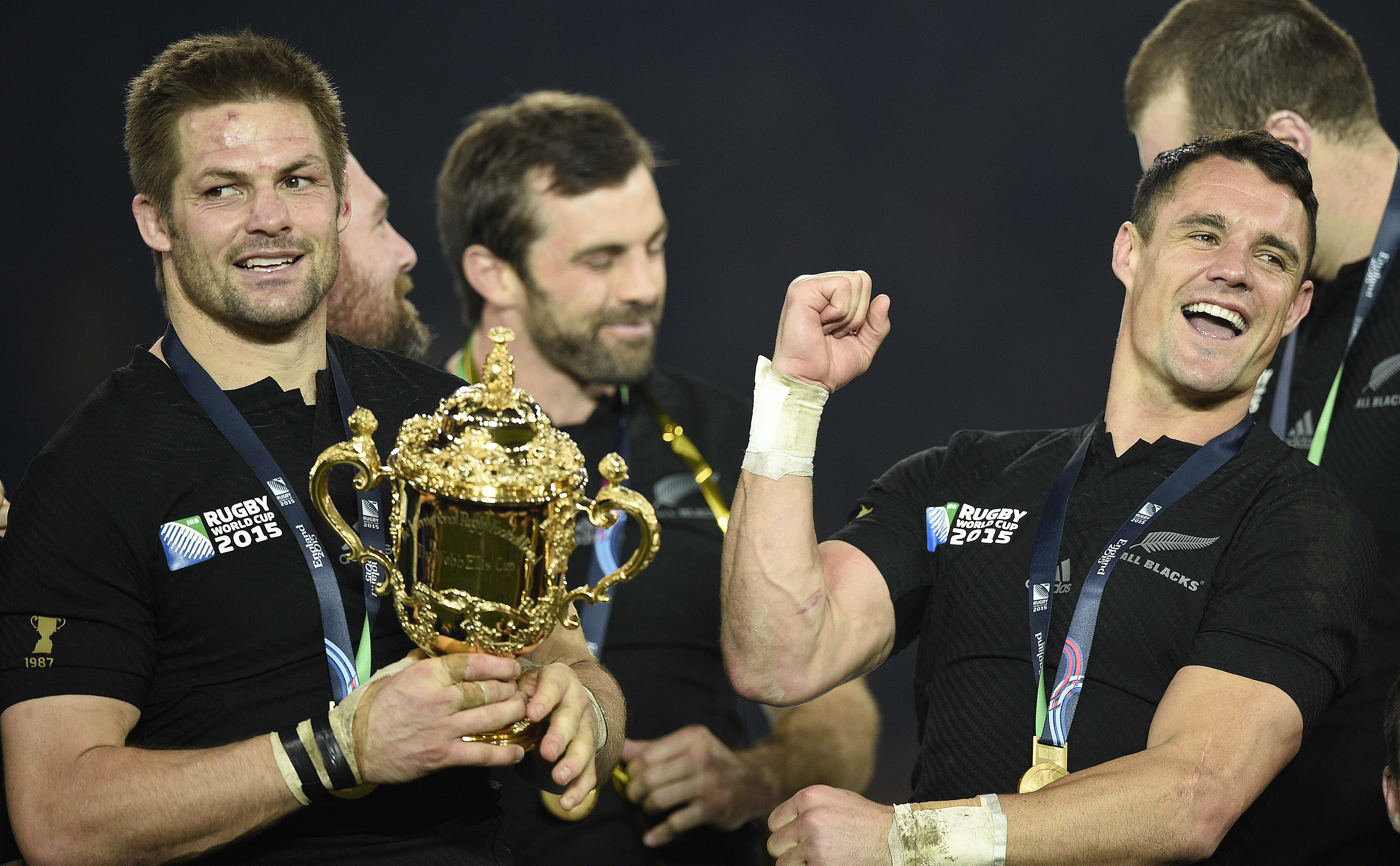 New Zealand's flanker and captain Richie McCaw (L) holds the Webb Ellis Cup next to New Zealand's fly half Dan Carter as they celebrate with teammates after winning the final match of the 2015 Rugby World Cup