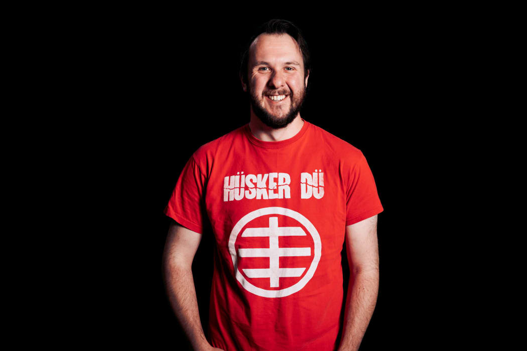 RNZ studio operator Elliott Childs in his Husker Du t-shirt