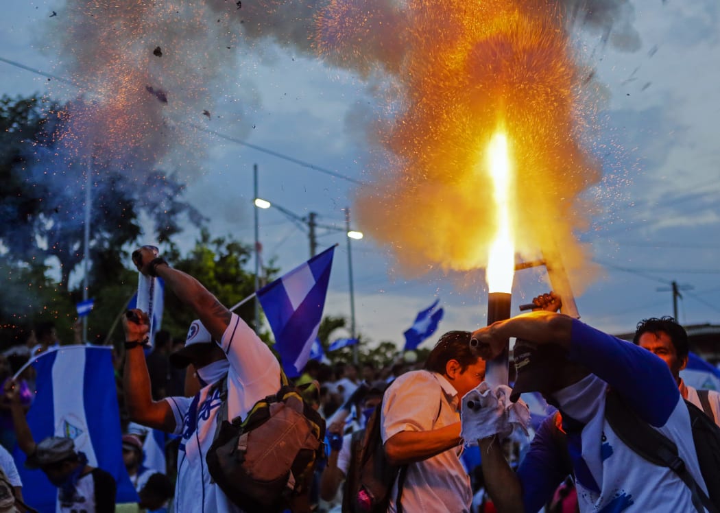 Demonstrators protest during a march from Catarina City to Niquinohomo City to demand justice for the deaths in recent protests in Niquinohomo City, some 40 km from Managua on May 5, 2018