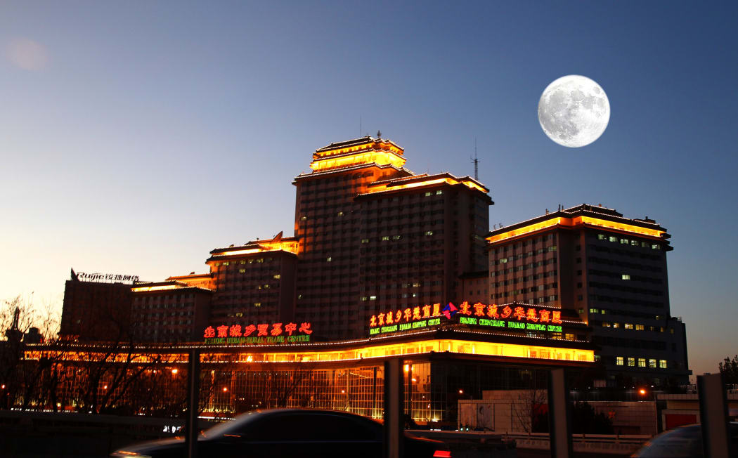 A supermoon is seen in the night sky over Beijing, on 3 December.