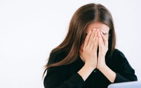 woman with head in hands