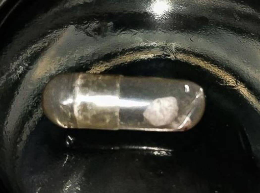 The pills are medium sized clear capsules containing a chalky white powder that clumps together.