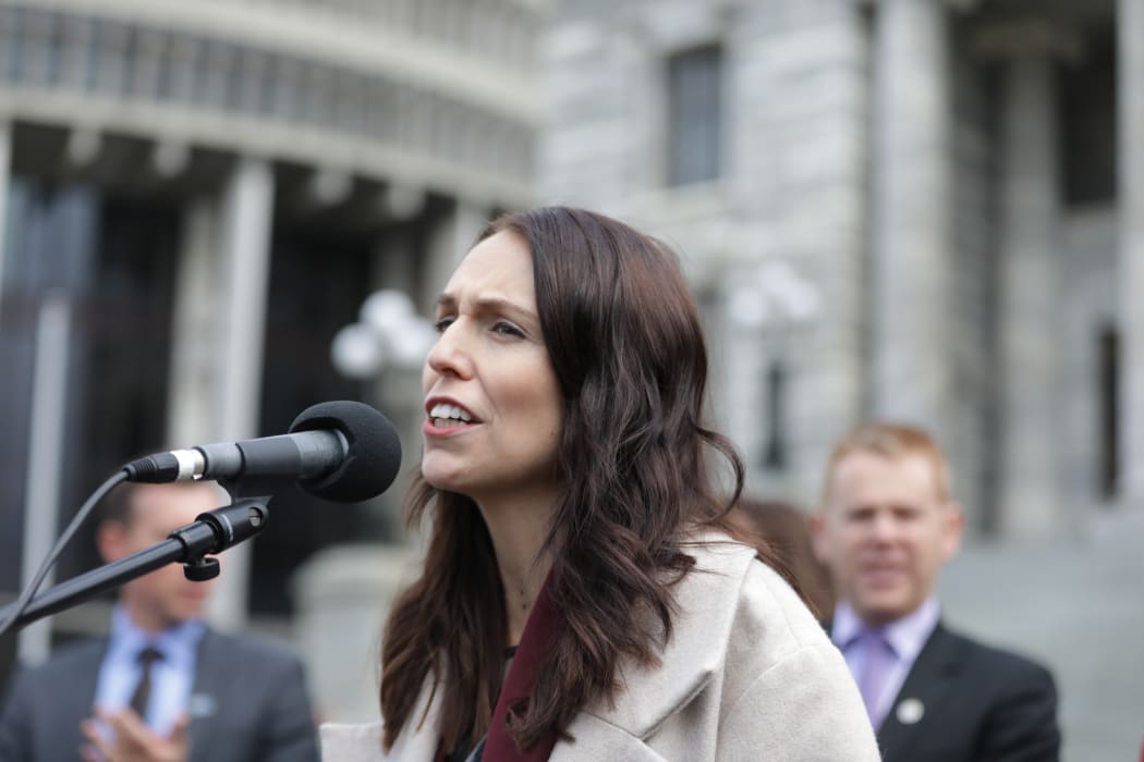 Prime Minister Jacinda Ardern speaks to striking teachers at Parliament grounds.